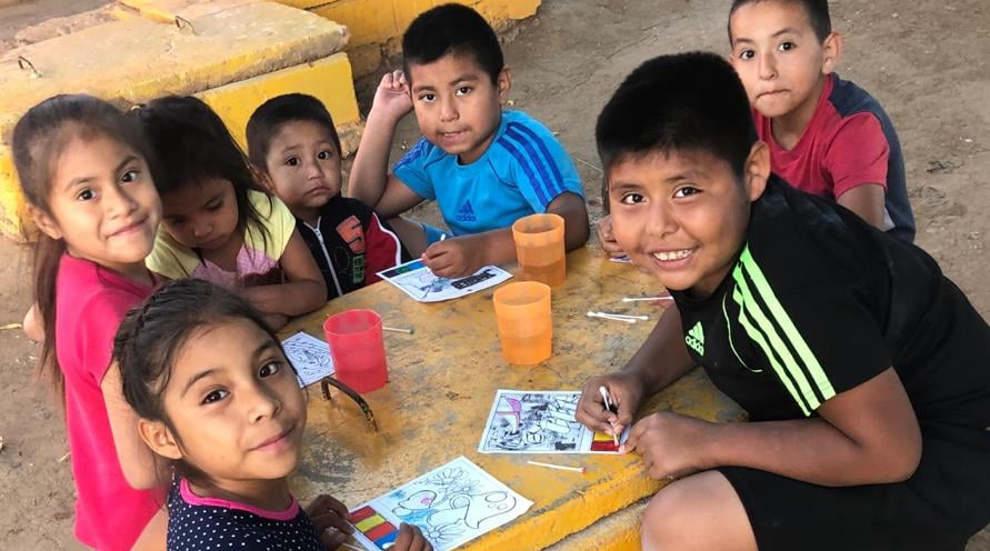 Children gathered around a table during a Bible club activity